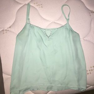 A tank top with silver beading around the neck