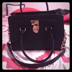 Brand new Michael Kors purse still has tag on it .