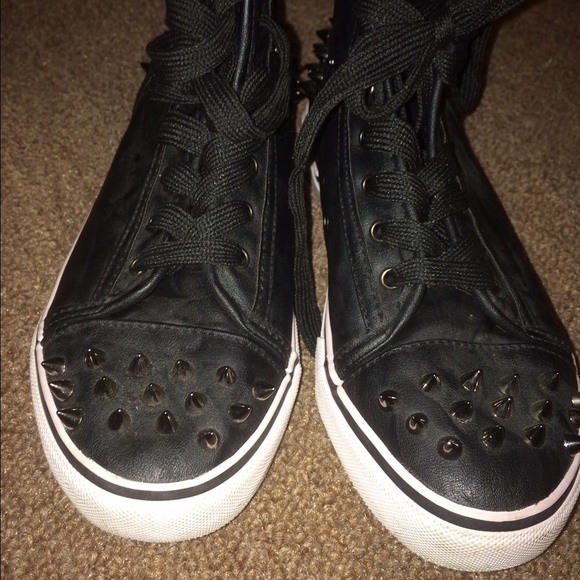 Black sneaker with decorative spikes
