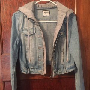 Jean jacket with gray sweatshirt hood