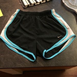 Black and blue nike running shorts
