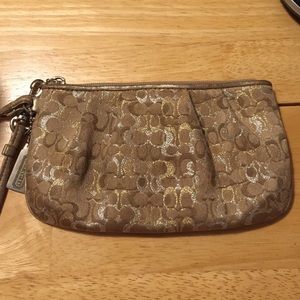 Gold, silver, beige coach wristlet.