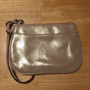 Sparkly gold coach wristlet.