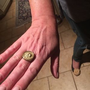 Alexander McQueen gold colored skull ring.