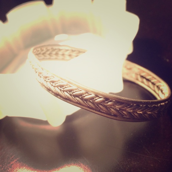 Silver tone metal bangle with rope braid design