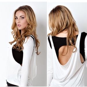 White and black long sleeve top with open back.