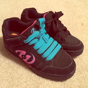 Old pair of heely's pink blue and black