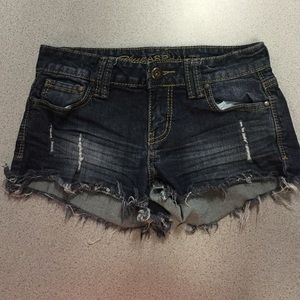 Blue asphalt cutoffs