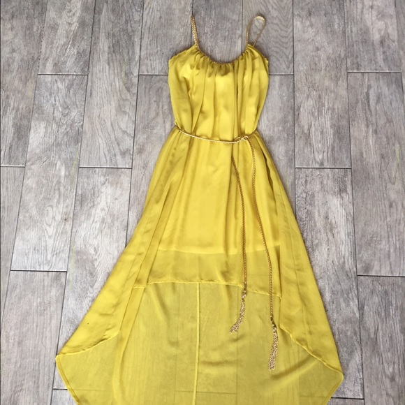 High-low dress with gold details and belt.