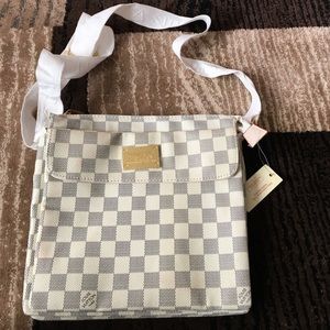 Off white/grey checkered cross body bag. No brand