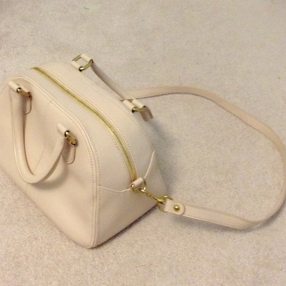A cream colored shoulder bag