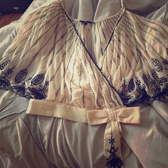 Cream top with black beading.