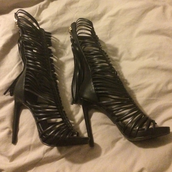 Black strappy sandals with tassel.