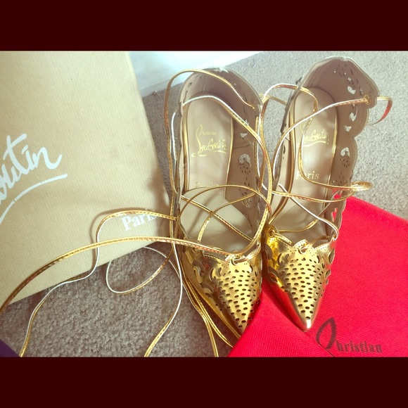 Gold lace up heels. With red soles.