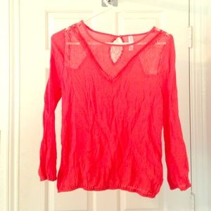 Cute Coral top with lace detail. Slightly sheer.
