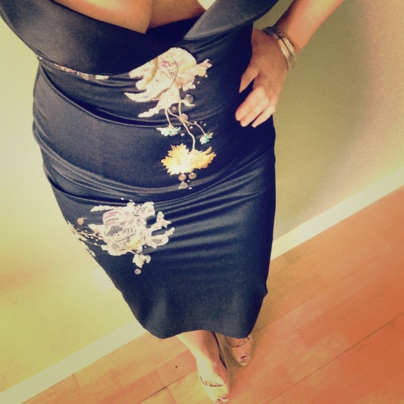 Satin knee length dress with flower appliqué.