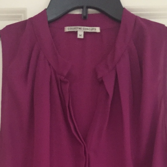 Hot pink sleeveless blouse.