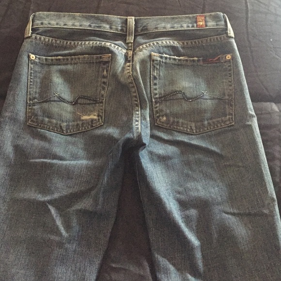 7 jeans. With stones in the back pockets .