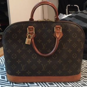Authentic Louis Vuitton Alma bag with lock.