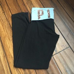 Black leggings with a blue with gold writing band
