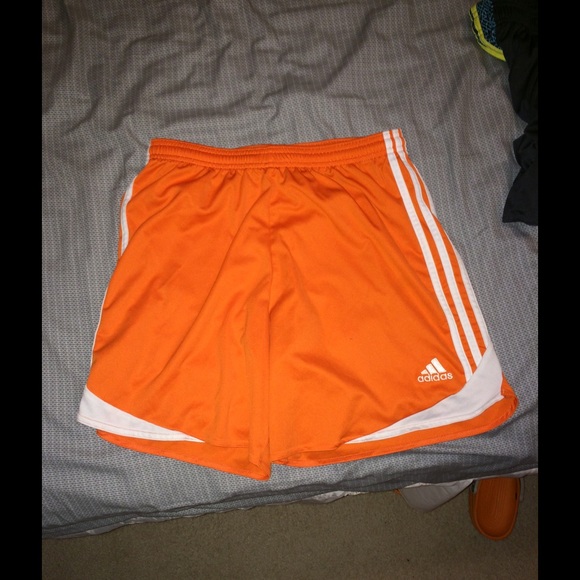 Orange Adidas women's shorts.
