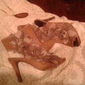 Nude flower booties, by report.