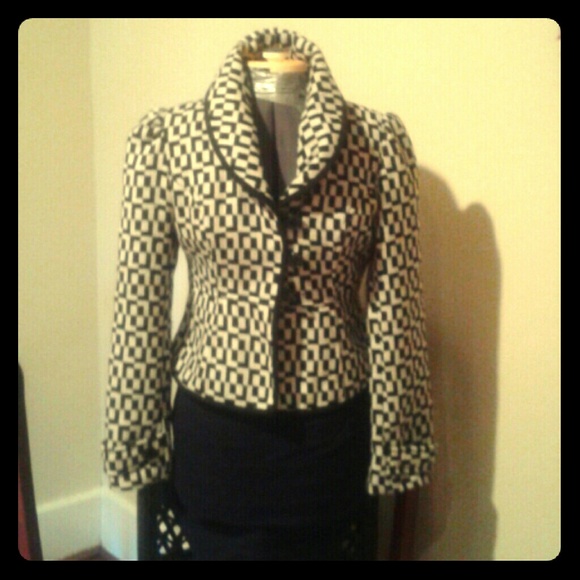 Chic black and white geometric, dramatic collar.