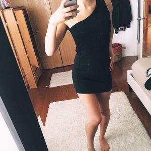 Black one shoulder dress.
