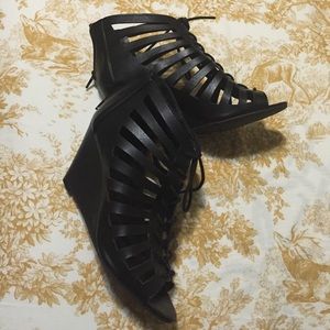 All black wedged strapped shoes
