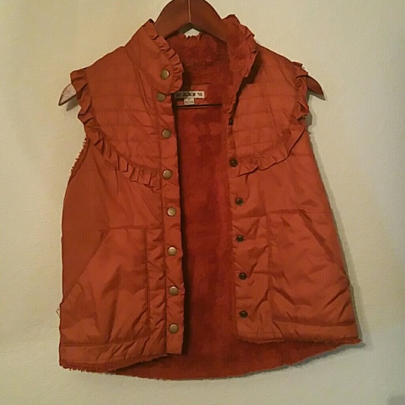 Orange puffer vest with ruffle details