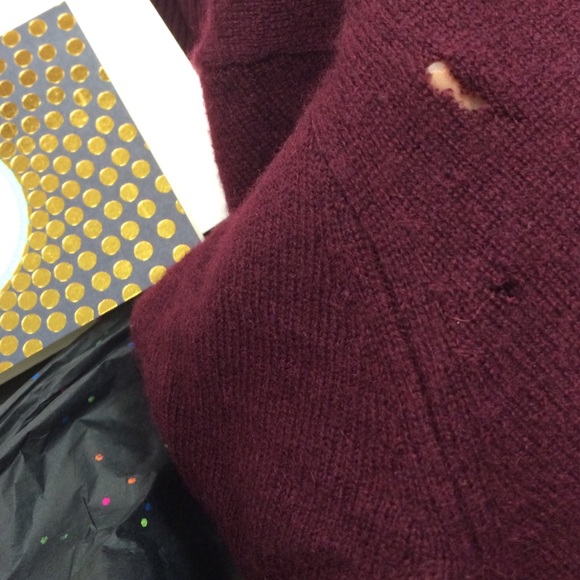 So sad :( beautiful sweater with big holes...