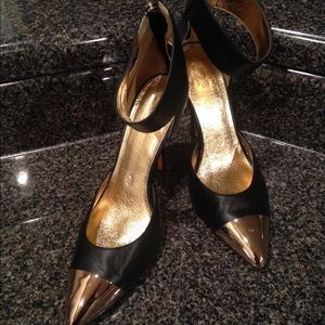 Gold tip black pumps
