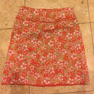 Pretty tan and orange skirt with flowers.