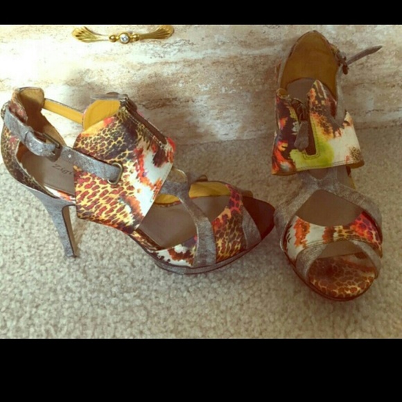 Multi colored shoes with ankle strap and zippers.