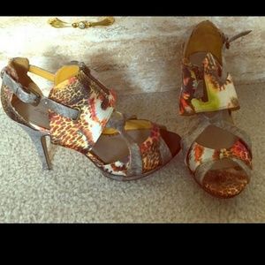 Multi colored shoes with ankle strap and zippers.