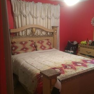 A queen bed with a six draw organizer and a mirror