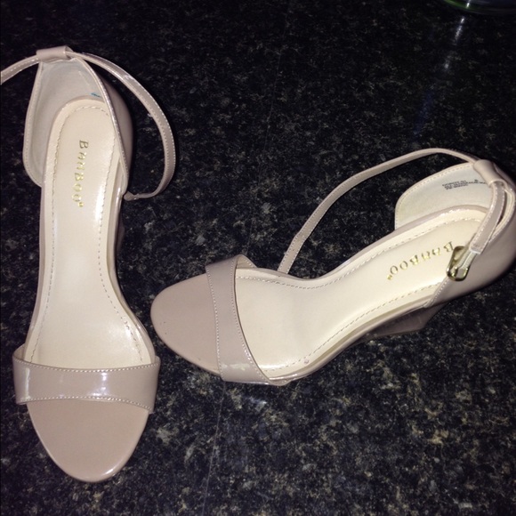 Patent leather nude wedges with ankle strap.