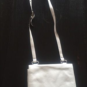 White shoulder bag.  Brand is Tignanello.