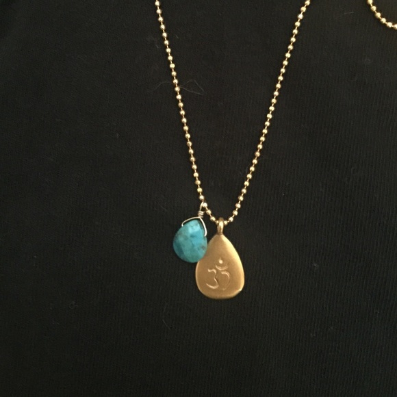 Satya gold necklace with OM charm and turquoise.
