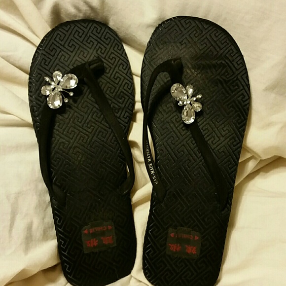 Black butterfly flip flops