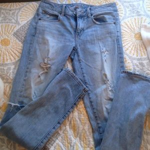 Light wash destroyed ripped straight leg jeans