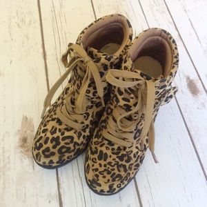 Leopard print lace-up wedge bootie.