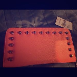 Coral wallet with gold studs . Brand new.
