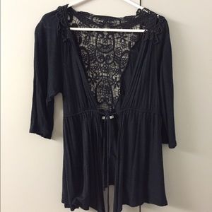 Black cardigan with crocheted back.