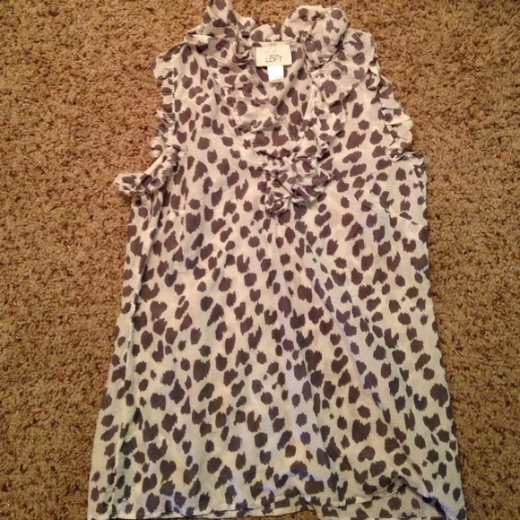 Sleeveless, cheetah print blouse.