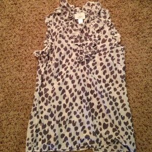 Sleeveless, cheetah print blouse.