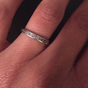 White gold band with 12 diamonds. Size 4.5