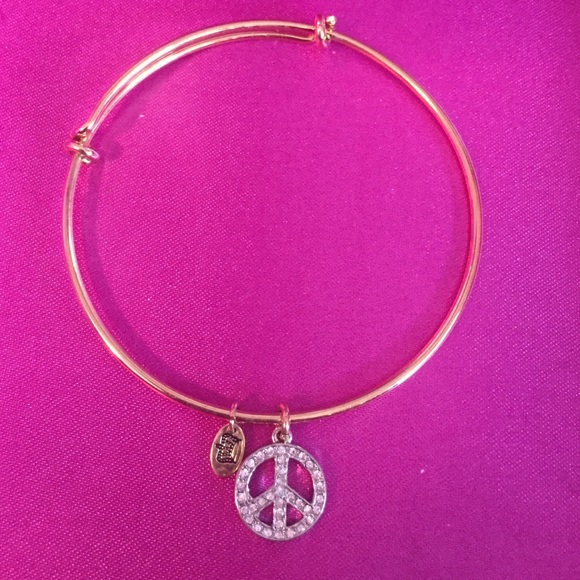 Gold juicy couture bangle with peace sign