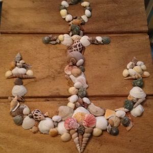 anchor made of shells on wood board