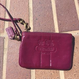Purple/mauve Coach wristlet